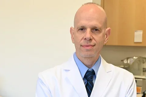 John close up with crossed hands