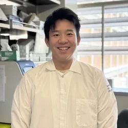 Phoenix is standing in the lab next to qPCR machine